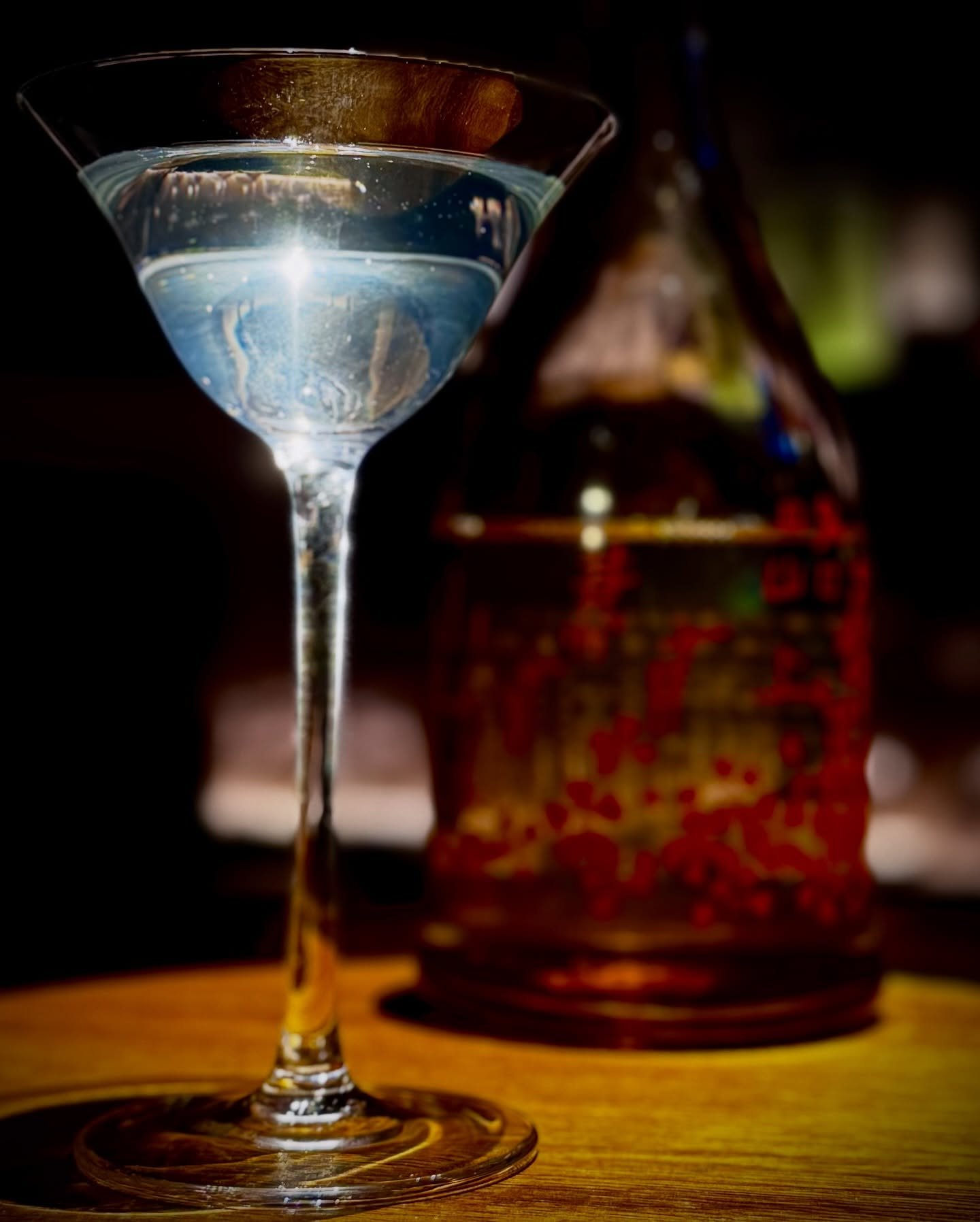 A blue cocktail in a stemmed glass at the Salon counter